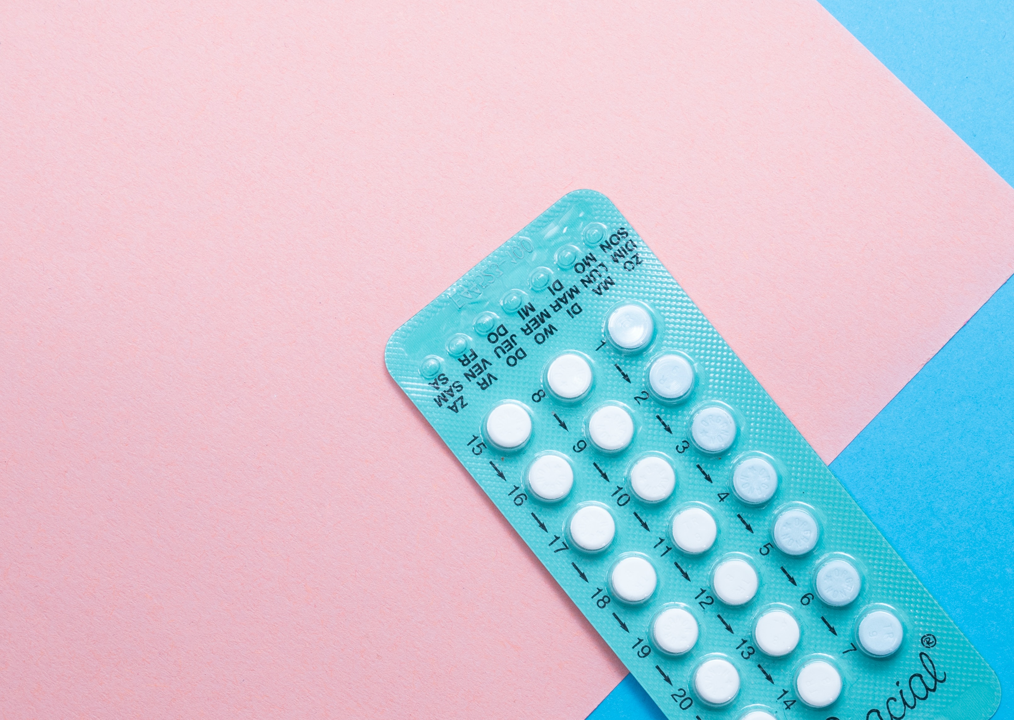Pill packet on blue pink background