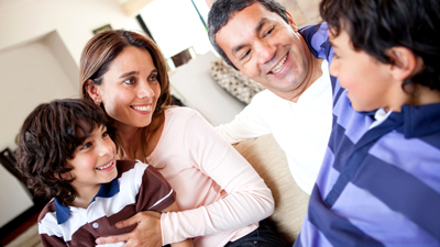 Smiling parents and two sons